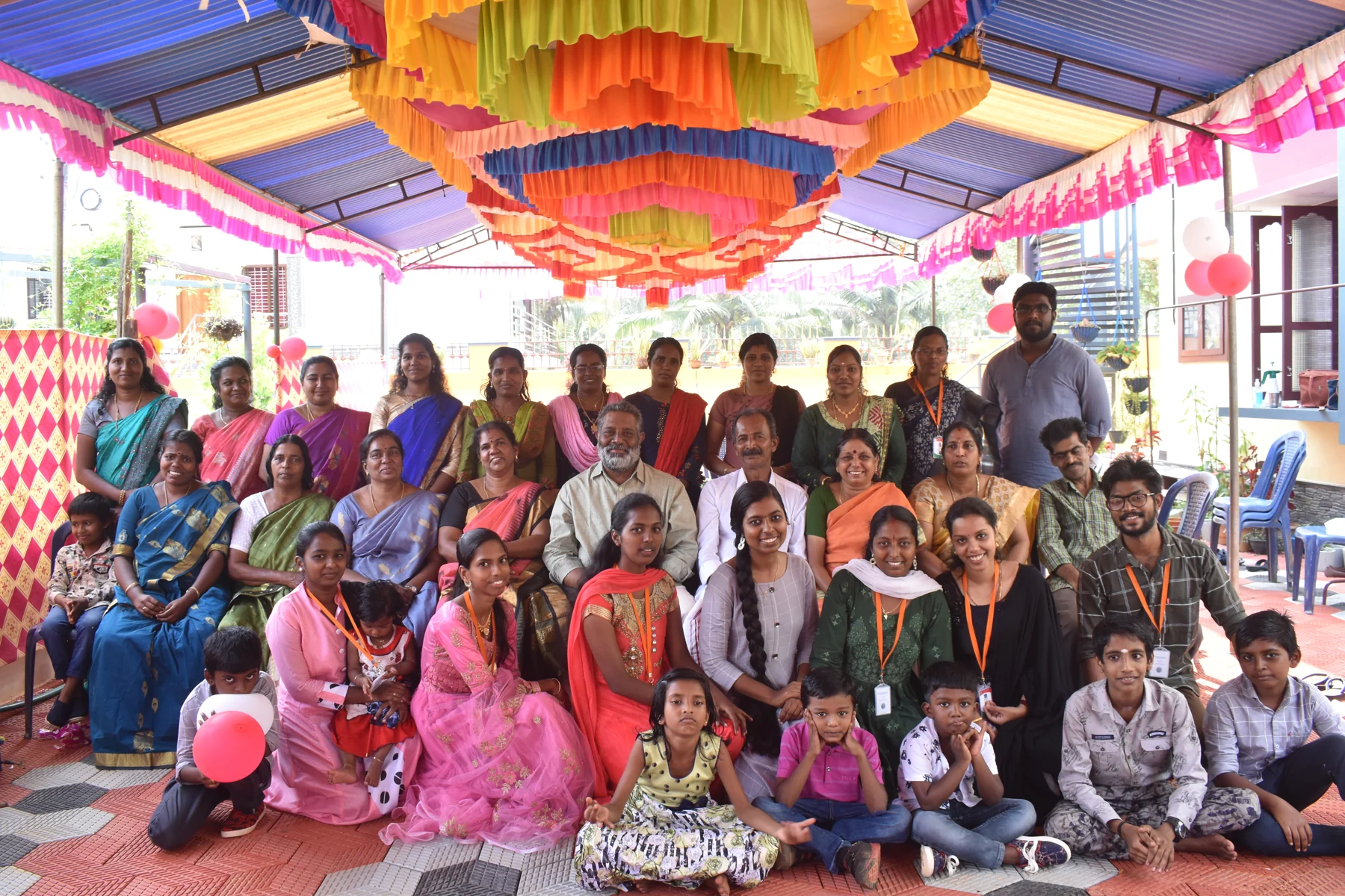 Families and volunteers together at a colourful community celebration