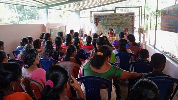 Women listening during a community meeting
