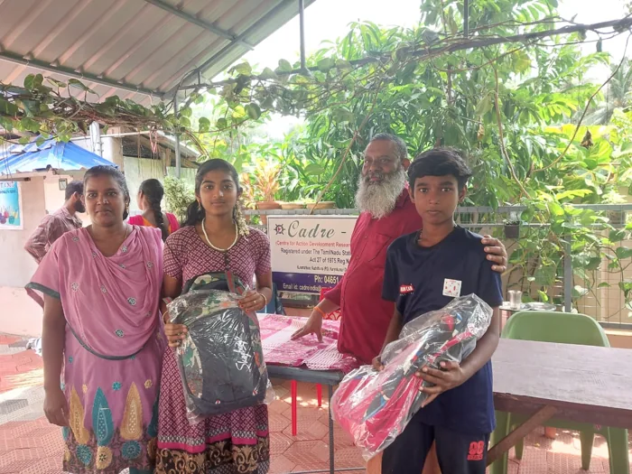 Young people receiving learning supplies at a community event