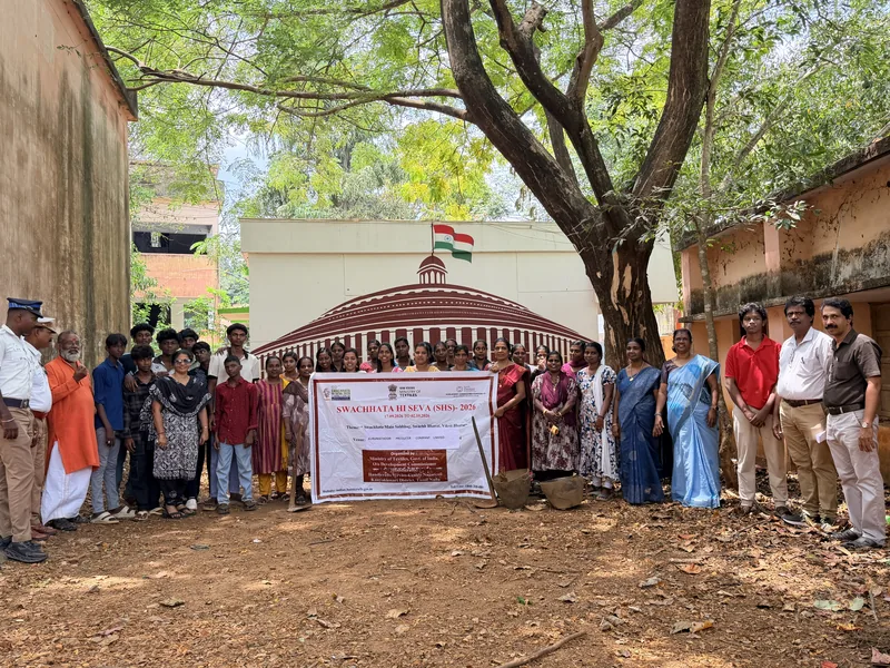 Staff and community members gathered at the school with the Swachh Bharat banner